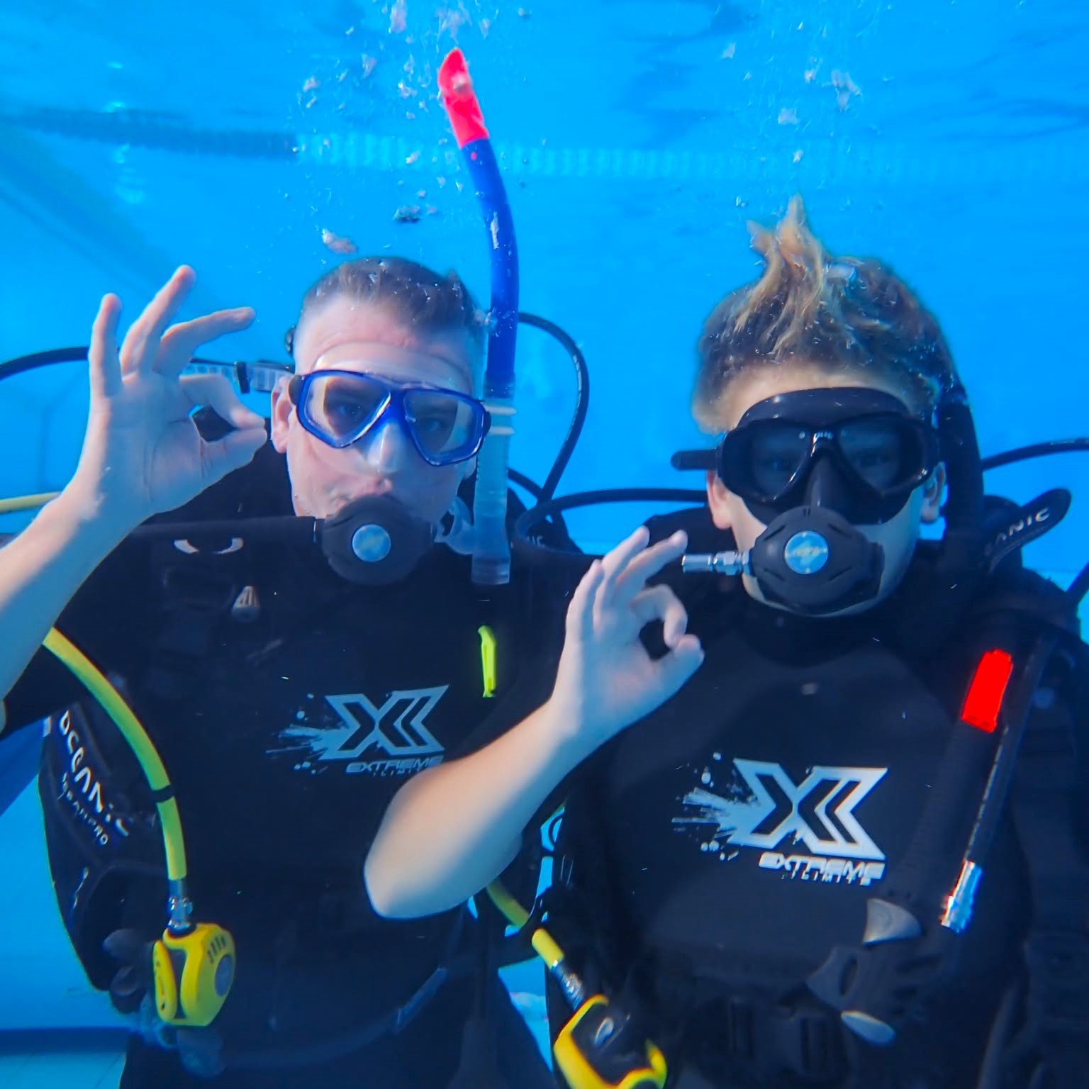 Father & son learning to scuba dive in the pool
